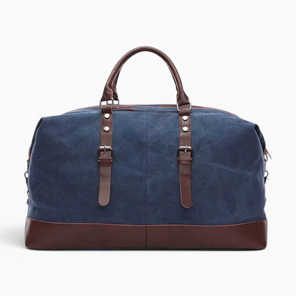 Sac de voyage bleu en toile et cuir synthétique avec sangles décoratives, style week-end robuste et spacieux.