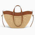 Sac sac seau en paille tressée beige avec garniture en cuir marron, idéal pour la plage ou l'été.